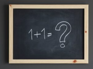 1+1=? written on chalkboard