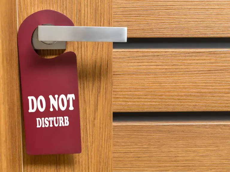 red do not disturb sign hanging on door knob