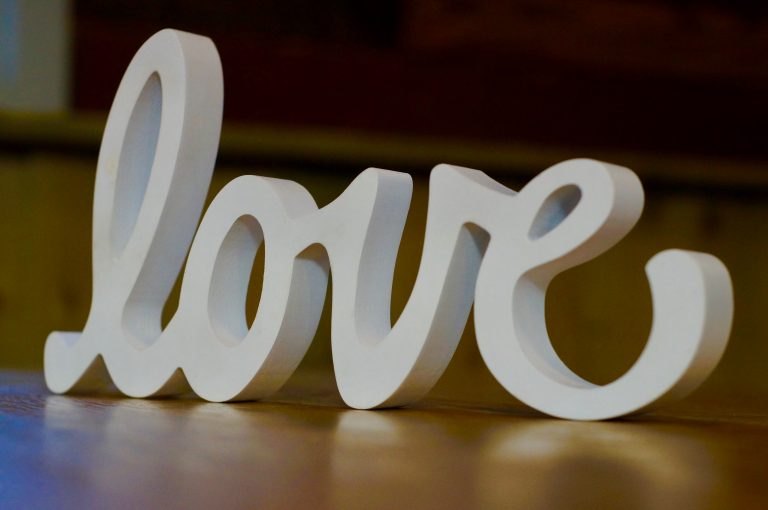 wooden sign that says love
