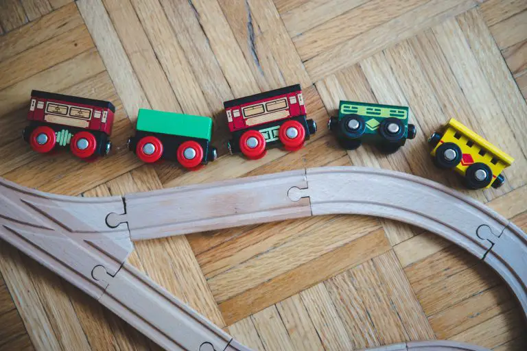 toy train and tracks laying on the floor