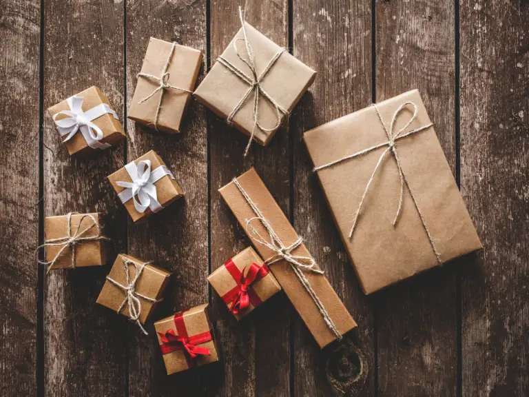 multiple gifts wrapped sitting on a wood background