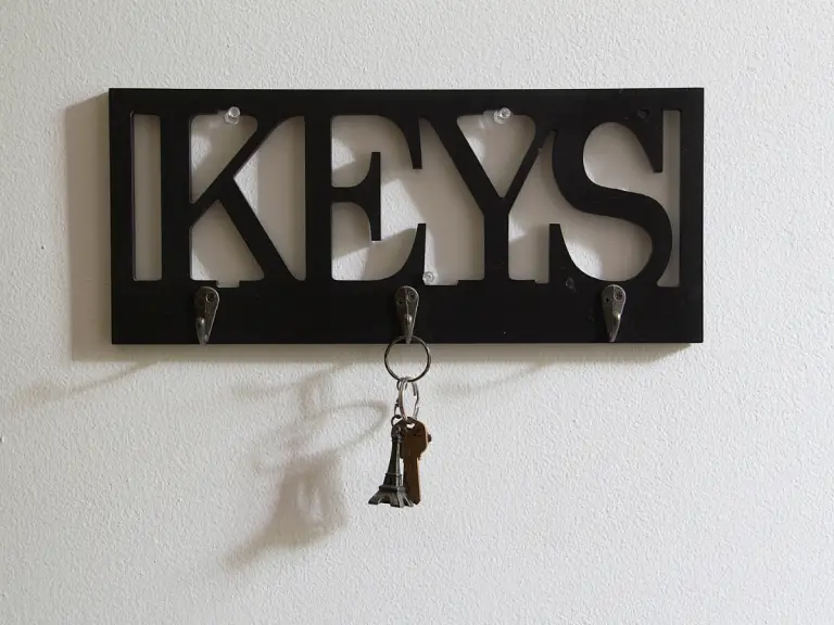 a black key holder with one set of keys on it