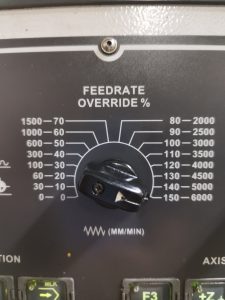 feedrate override knob on a Lillian VMC 1100 CNC mill
